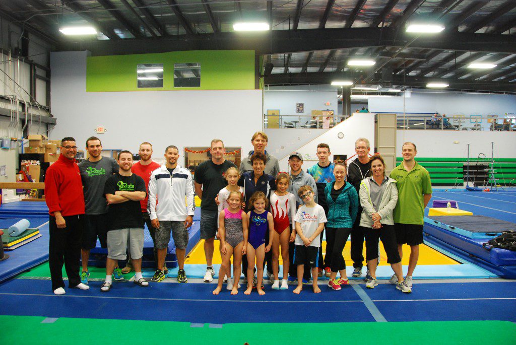 The Roots Gymnastics Team staff is joined by Trampoline Development Coordinator Joy Umenhofer, center, gymnasts, and other area coaches. (Submitted photo