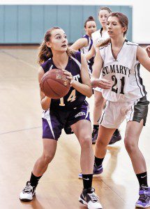 Westfield Voc-Tech's Heather Lannon, left, looks for the net as St. Mary's Elisa Kosinski moves in during the first period of Friday night's game at Westfield Middle School North. (Photo by Frederick Gore)