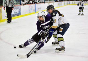 Cathedral's Madison Pelletier, left, battles Shrewsbury Karli Desouza Friday night at the Amelia Park Ice Arena. (Photo by Frederick Gore)
