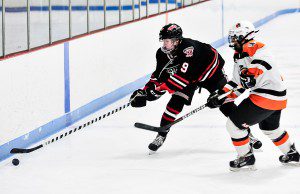 Westfield's Connor Sullivan, left, snags control of a loose puck. (Photo by Frederick Gore)