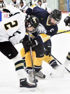 St. Mary's Andrew Andrew Booth, left, battles Mt. Everett's Peter Lovejoy Monday at the Amelia Park Ice Arena. (Photo by Frederick Gore)