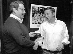 Kevin Regan, then president of the Westfield firefighters' union, presents a miniature firefighter's badge to former firefighter Robert Derock at his retirement party in 1993. (Photo ©1993 Carl E. Hartdegen)