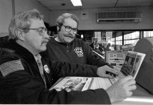 Kevin Regan (right) looks over a 1996 firefighters' calendar with retired fire Capt. Dan Wojik in 1995. (Photo ©1995 Carl E. Hartdegen) 