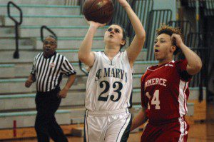 St. Mary's Alissa Easton (23) flashes by Commerce's Tiana Bunn, right. (Photo by Chris Putz)