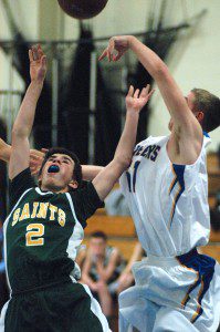 Nick Garde (2) goes airborne for the St. Mary High School boys' basketball team Thursday night at Pathfinder. (Photo by Chris Putz)