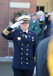Westfield Fire Chief holds a salute as her brother’s casket is moved from Our Lady of the Blessed Sacrament Church after his funeral Saturday. (Photo by Carl E. Hartdegen)
