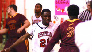 Westfield's Richie Barnett (21) extends his arms on defense against visiting Chicopee Monday night. (Photo by Chris Putz)