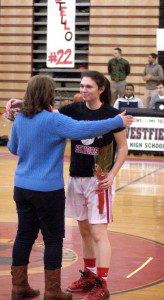 Westfield High School girls' basketball senior Karly Mastello is congratulated on senior night Monday. (Photo by Chris Putz)