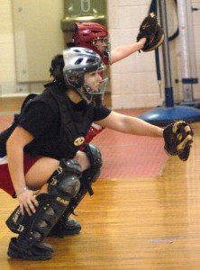 Catchers get in their stance inside the WHS gymnasium Monday. (Photo by Chris Putz)