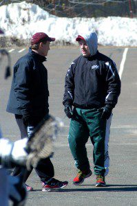 The WHS boys' lacrosse coaching staff has a discussion during practice outside the Bombers' gymnasium Monday. (Photo by Chris Putz)