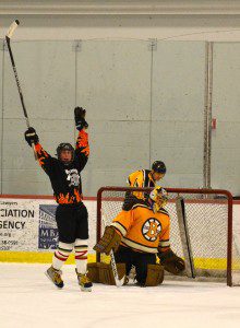 Westfield Fire Department's Jake Neilsen celebrates a goal against the Legends in the annual fundraiser at Amelia Park Ice Arena in March. (Staff photo)