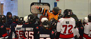 Local youth hockey players receive instruction from a Legends player.