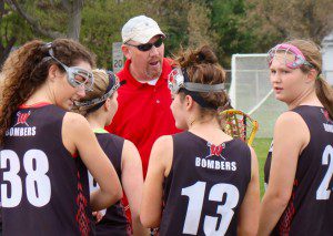 Westfield High girls'  lacrosse coach Paul Fenwick talks to his players during a break in the action Wednesday in Longmeadow. (Photo by Chris Putz)