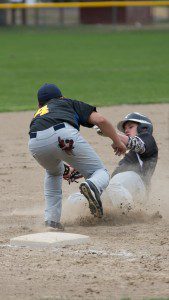 Nate Boulay attempts to avoid the tag while sliding into third against Putnam. (Photo by Liam Sheehan)
