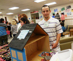 Steve Robtor, a student in the program, brought a prototype doll house he had made to the open house, along with a survey asking people which features they would like to see in a doll house, and how much they would pay for one. (Photo by Amy Porter)