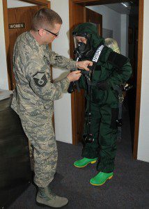 Master Sgt. Christopher McCrary, Emergency Management Flight non-commissioned officer in charge, Barnes Air National Guard Base, inspects Airman 1st Class Neal Colburn and active-duty Staff Sgt. John Gaylord in their Personal Protection Level-B suits during an exercise May 6 at Spangdahlem Air Base, Germany. The Guard and active-duty Airmen are training together on Active CBRNE (Chemical Biological Radiological Nuclear and High- Yield Explosives) Response to enhance their Hazmat Technician Certification. This is a required training that needs to be done by the guard and the active duty. Doing the training together allows them to increase their knowledge by sharing their experiences and use different types of equipment. (U.S. Air National Guard photo by Tech. Sgt. Melanie J. Casineau/Released)