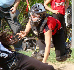 Bombers' catcher Madison Brockney tags out a Lancer at home plate Monday. (Photo by Chris Putz)