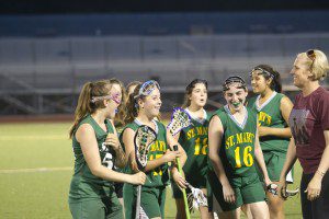 St. Mary's Lauren Chapdelaine (17), front second from left, cracks a smile as she is congratulated by teammates after scoring her 100th career goal Tuesday night. (Photo by Jeff Hockenberry/www.jchphotos.com)