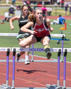 Morgan Sanders leaps during the 110 meter hurdles Championship on Saturday at Holyoke High School.  (Photo by Liam Sheehan)