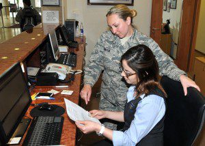Staff Sgt. Adrianne Johnson, 104th Services Flight, Barnes Air National Guard Base, receives training on front desk procedures from Ayesgui Gignac, Guest Services Representative, May 7, 2015, on the front desk computer system, Air Force Inn, Kaiserslautern Military Community Center, Ramstein Air Base, Germany. Johnson trained at the KMCC Air Force Inn May 5-7 in the areas of housekeeping, inspecting rooms, accounting, reservations, and supply, allowing her to sign off on requirements for her services position. (U.S. Air National Guard photo by Tech. Sgt. Melanie J. Casineau/ Released)