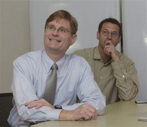 Western New England University Prof. Harlan Spotts, left, and entrepreneur Daniel Koval during an on-line video chat with Sergey Kolyubin, CEO of XTurion, a home security company based in Russia, May 7, 2015. (Michael S. Gordon/The Republican via AP)