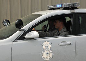 Senior Airman Gregory Warren, Airman 1st Class James Doig, and Airman 1st Class Gerald Nastari, 104th Security Forces Squadron, Barnes Air National Guard Base, , train in a police vehicle May 12, 2015, Ramstein Air Base, Germany. The 104th SFS members do not have police cars back at Barnes, and after training on the vehicle, were able to augment Ramstein law enforcement May 5-15. (U.S. Air National Guard photo by 2nd Lt. Bonnie Harper/Released)