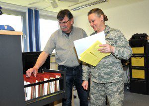 Master Sgt. Lori Rowe, 104th Contract Specialist, Barnes Air National Guard Base, works with Erich Reisinger, civilian contractor, 700th Contracting Squadron, May 7, on a new file plan, Kapaun Air Station, Germany. Rowe created a file plan that could track the status of various construction projects, guaranteeing the correct filing and documentation of active and completed projects. (U.S Air Force photo by Tech. Sgt. Melanie J. Casineau/Released)