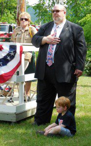 State Senator Don Humason, accompanied by his son Quinn, thanked those who served throughout history, and those who serve today. Longtime VFW member and parade organizer Barb Carrington, is shown on his left. (Photo by Amy Porter)