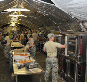 Members from the 104th Services Flight, Barnes Air National Guard Base, prepare dinner in a busy kitchen May 13, during Exercise Silver Flag, Ramstein Air Base, Germany. Silver Flag is a U.S. Air Force training course designed to educate airman with valuable skills allowing them to know how to deploy using real-world equipment in real-world scenarios. (U.S. Air National Guard photo by Tech. Sgt. Melanie J. Casineau/Released)