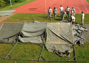 Members of the 104th Services Flight work together to set up a temporary tent May 11 at  Ramstein Air Base, Germany, in preparation for exercise Silver Flag. Silver Flag is an eight-day training course designed to prepare Airmen for any bare-base deployment.(U.S. Air National Guard photo by 2nd Lt. Bonnie Harper)