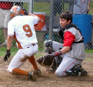 Westfield Little League Senior All-Stars catcher Cam Sporbert attempts to place the tag on Agawam's Jimmy Adams (9) at home plate. Adams was ruled "safe." (Photo by Chris Putz)