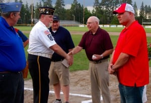 A longtime baseball coach and United States Army Veteran, Emmet F. Morrill, second from right, is honored during a special pregame ceremony during the Westfield Post 124-Easthampton Post 224 American Legion baseball game Tuesday night at Bullens Field. (Photo by Chris Putz)