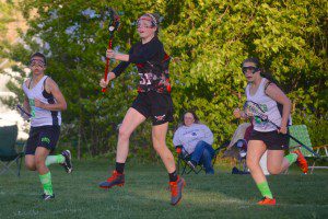 Westfield Girls' Lacrosse Senior Red Team member Jordan Kowalski makes a pass to a teammate.