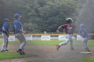 Nick Lenfest (far right) covered first base to receive the throw from Jacob Wagner (far left) to retire Easthampton's Sean O'Leary in the third inning Tuesday. After committing five errors Sunday in their loss to Westfield National, Westfield American committed just three errors en route to their 5-4 win.