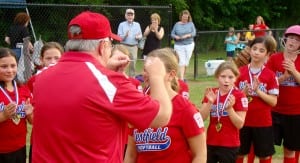 Westfield Little League President Ken Diegel, left, presents medals to each member of the 9-10-year-old softball All-Stars during a special postgame ceremony. The Whip City placed second in the state championship tournament. (Photo by Chris Putz)