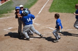 Liam Poole (left, blue helmet) hit a three-run home run in the bottom of the third inning to give Westfield American a 3-1 lead, The eventual game-winning hit barely cleared the wall at Papermill--200 feet away from home plate.