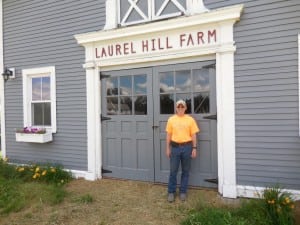 David Hopson standing in front of the Laurel Hill Farm horse barn, one of the original buildings from the 20s. (Photo by Amy Porter)