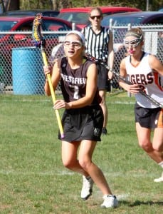Westfield's Gabby Lunardini (7) possesses the ball against South Hadley during a field hockey game last season. Lunardini, now a senior captain, will attempt to lead the Bombers in 2015. (Photo by Chris Putz)