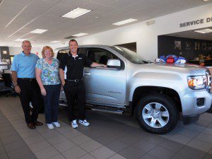 Don Pion, Judy Whalen and Tom Pion show off a 2016 GMC Canyon in the showroom.  (Photo by Amy Porter)