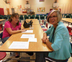 Abner Gibbs parent Heather Talbot discusses new report cards with retired principal Leslie Clark-Yvon. (Photo by Amy Porter)