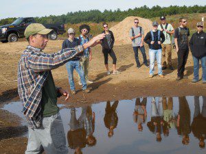 Kubel shows students a vernal pool made out of existing materials two weeks ago that is retaining water.