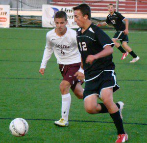 Westfield’s Dillion Bazegian (12) dribbles the ball up the field as Ludlow’s Colby Johnson (4) shadows the play Friday night. (Photo by Chris Putz)