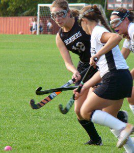 Westfield’s Rachel Gelina, left, attempts to ward off Longmeadow defenders in a race to the ball. (Photo by Chris Putz)