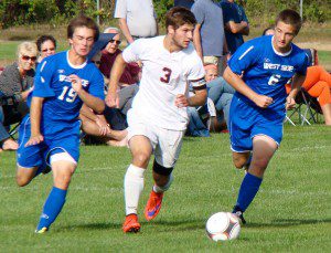 Bombers’ Matt Butera attempts to split a pair of West Side Terriers Friday at Westfield High. (Photo by Chris Putz)