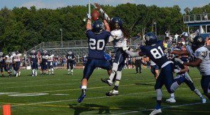 Colin Smith (20) leaps to try to make the catch on the final play of the game as UMass Dartmouth's DaVon Fuller (7) defends. (Kiley Berube photo)