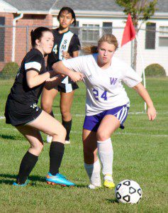 Westfield Technical Academy’s Emily White (24) attempts to beat Smith in a race to the ball. (Photo by Chris Putz)
