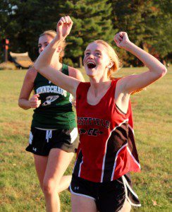 Westfield's Casey Becker celebrates during a high school girls' cross country meet. (Photo by Kate McCabe)