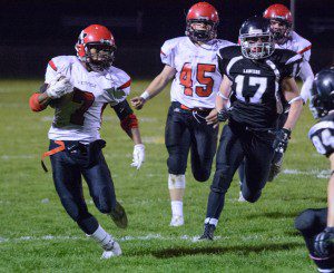 Westfield junior running back Wilton Royal, left, carries the ball against Longmeadow Friday night at the Lancers’ home field. (Photo by Marc St. Onge)