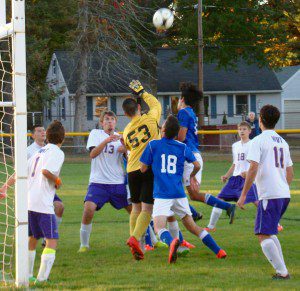 Westfield Tech goalie Anatoliy Suprunchuk (53) bats the ball away from the goal as players for both teams collide inside the box Monday at Bullens Field. (Photo by Chris Putz)