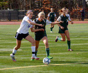Southwick's Amber Nobbs attempts to stave off Granby's Nora Young, left, while dribbling the ball upfield in Sunday's MIAA Girls' Soccer West Sectional Division 3 championship at Westfield State University. (Photo by Lynn F. Boscher)